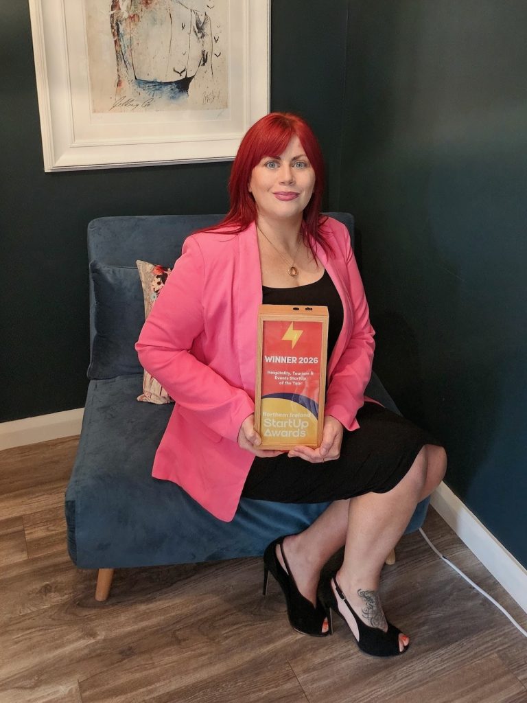 image showing Grainne Bankhead seated and proudly displaying her award